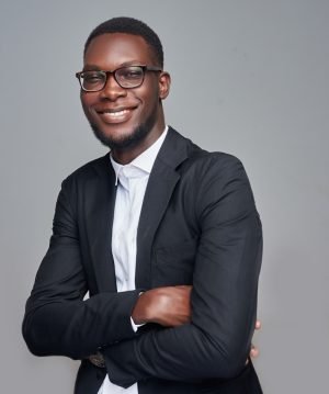 a man in a suit and glasses posing for a picture